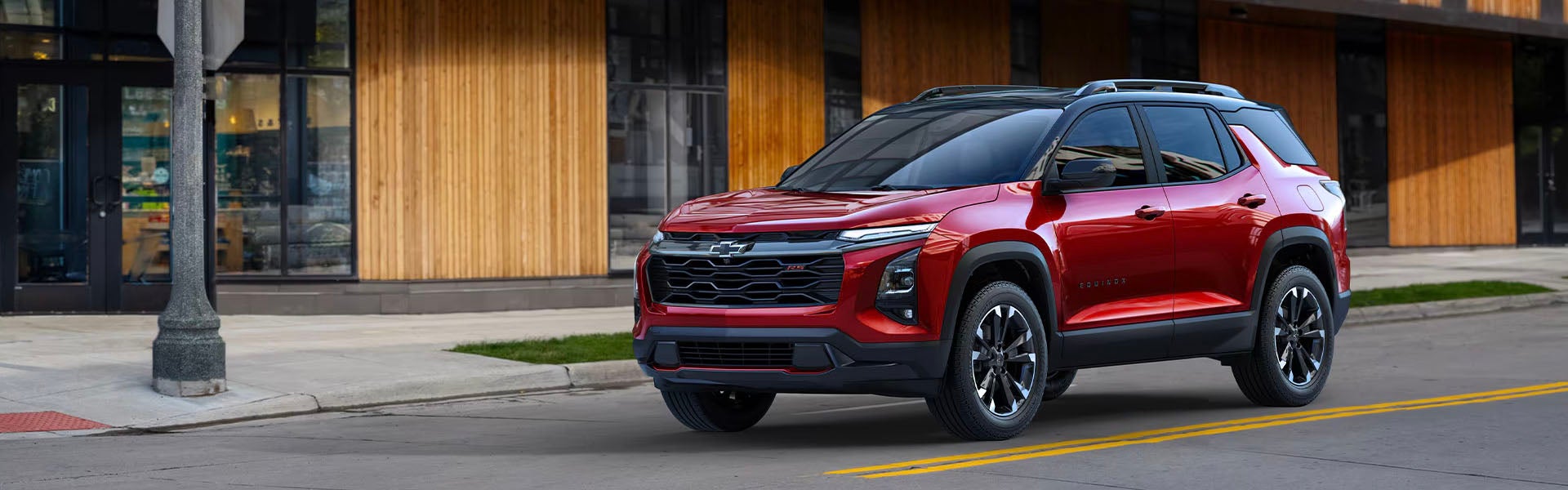 A Chevy Equinox stopping on city cross road.
