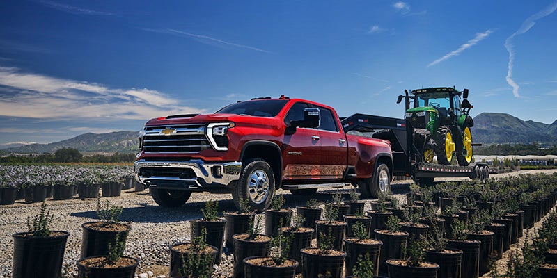 2025 Chevy Silverado 3500HD towing heavy equipment in Lewes, DE